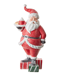 Santa Standing on a pile of Gifts holding a Platter of Goodies and a Cocoa