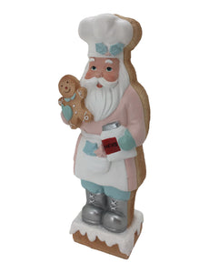 Baking Santa Claus holding a tray of Gingerbreads