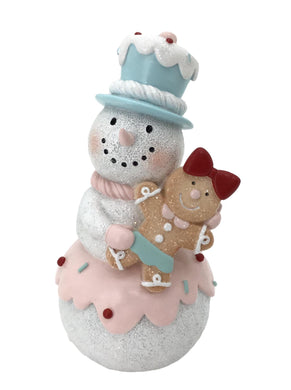 Standing Snowman Wearing a Candy Blue Hat holding a Gingerbread Girl