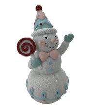 Load image into Gallery viewer, Standing Snowman Wearing a Candy Blue and PInk Hat holding a Swirl Lollipop.